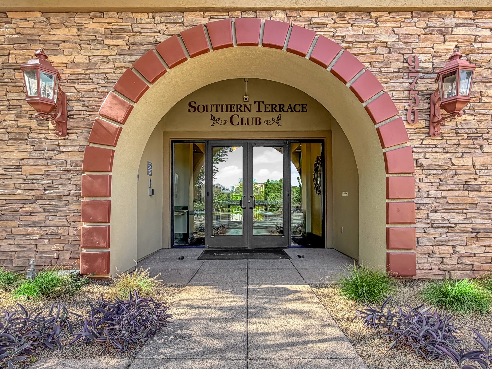 Entrance to the Southern Terrace Club, a stone archway with the clubhouse name above the door