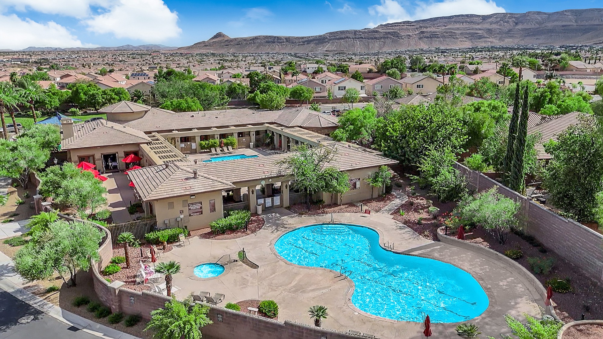 Aerial view of the Southern Terrace clubhouse pool and spa, with the neighborhood and Spring Mountains beyond